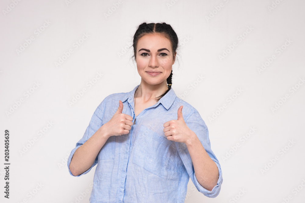 Portrait of happy beautiful brunette girl showing ok on grey background. Portrait of happy beautiful brunette girl showing ok on grey background.