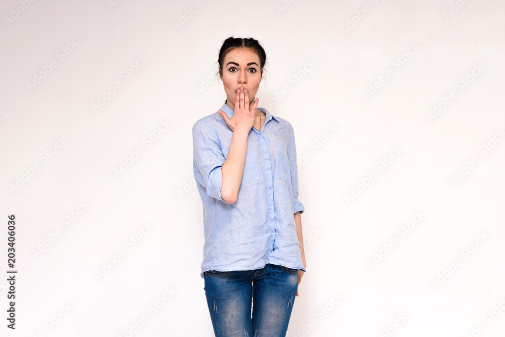 Portrait of a beautiful brunette girl on a gray background showing emotions Portrait of a beautiful brunette girl on a gray background showing emotions