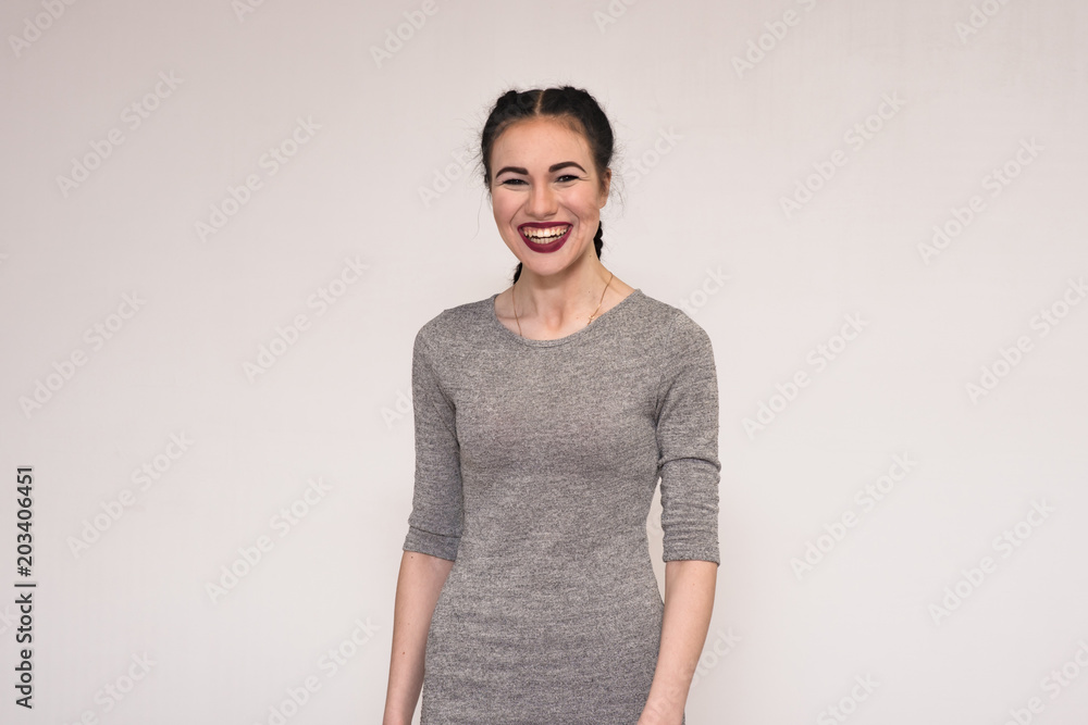 Portrait of a happy beautiful young brunette girl on a white background. Portrait of a happy beautiful young brunette girl on a white background.