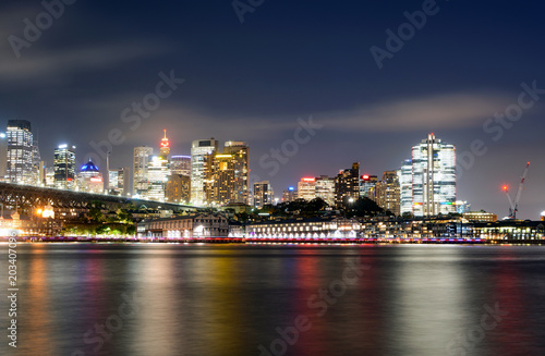 Colorful light reflections on the water from the central business district in Sydney  Australia at night