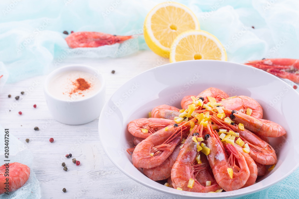 Boiled shrimps, are served with sauce from a curry, a lemon and spices Boiled shrimps, are served with sauce from a curry, a lemon and spices