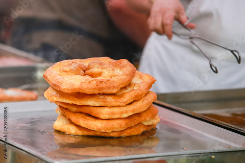 Baked johnnycake on a food stand ready for sale. photo