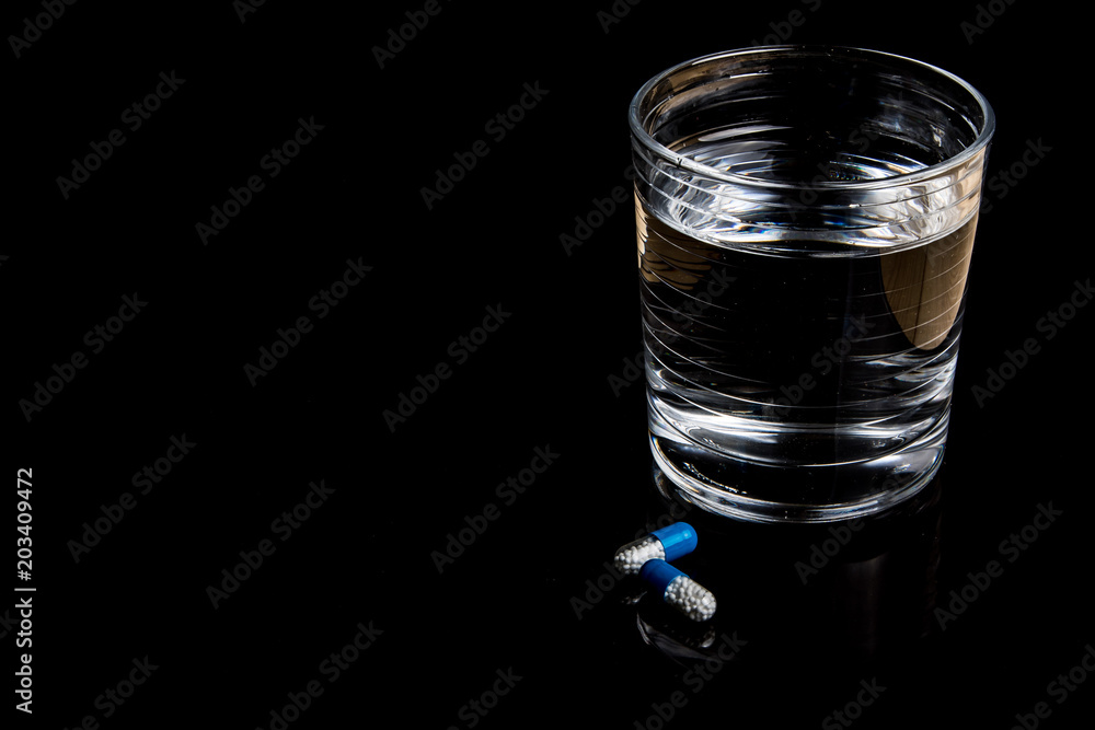 Medical pills isolated on a black background Medical pills isolated on a black background