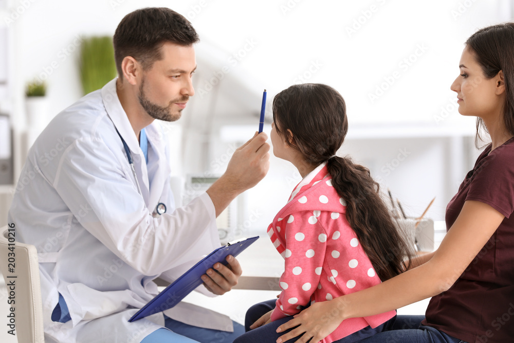 Fototapeta premium Woman with her daughter at doctor's office