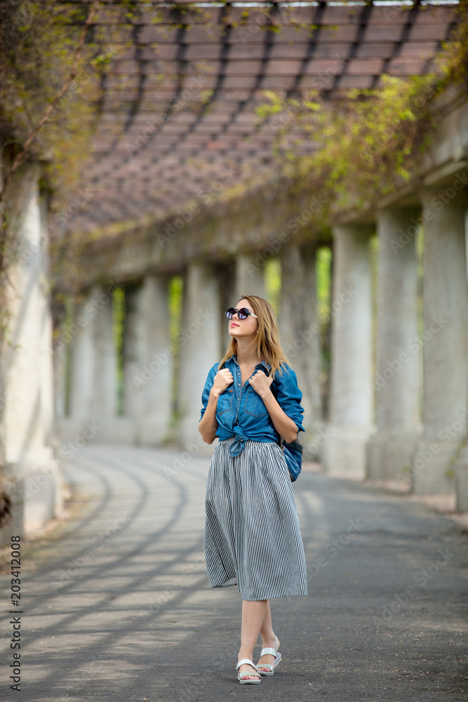 Young girl with backpack walking on alley with arches and columns in Wroclaw, Poland Young girl with backpack walking on alley with arches and columns in Wroclaw, Poland