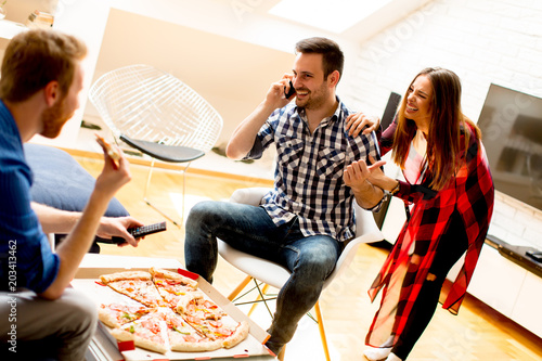 Young friends eating pizza ...