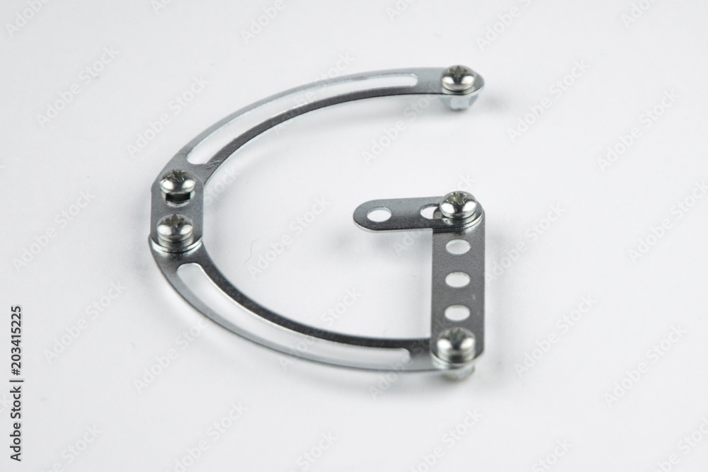 Letter G from the English alphabet of Children's metal designer kit, front view from the top, a short focus on the center Letter G from the English alphabet of Children's metal designer kit, front view from the top, a short focus on the center