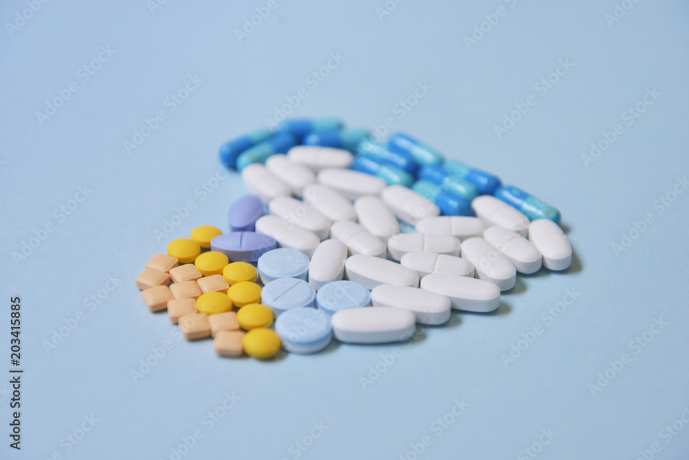 Healthcare and medical series - heart shape of medicine pills, tablets and capsules on background