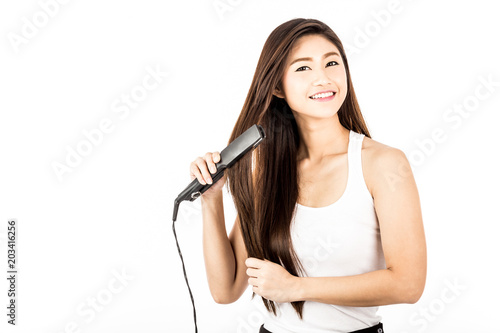 Beautiful Attractive Asian woman smile and holding Hair straighteners feeling so confident and happiness,Isolated on white background,Haircare Concept