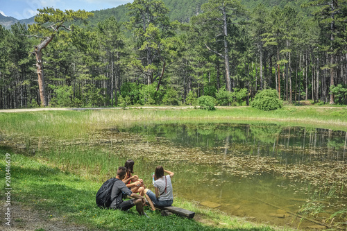 tourists on the lake in the forest