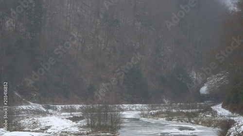 Mocanita rolling along Vaser River at winter photo