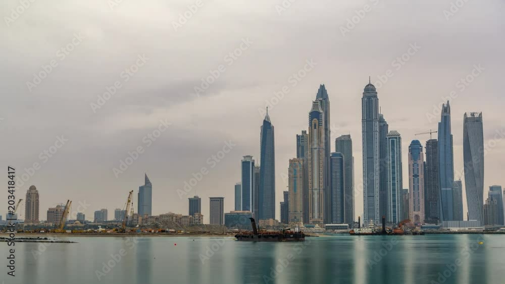 Panorama of modern skyscrapers in Dubai city at sunrise timelapse from the Palm Jumeirah Island. Panorama of modern skyscrapers in Dubai city at sunrise timelapse from the Palm Jumeirah Island.