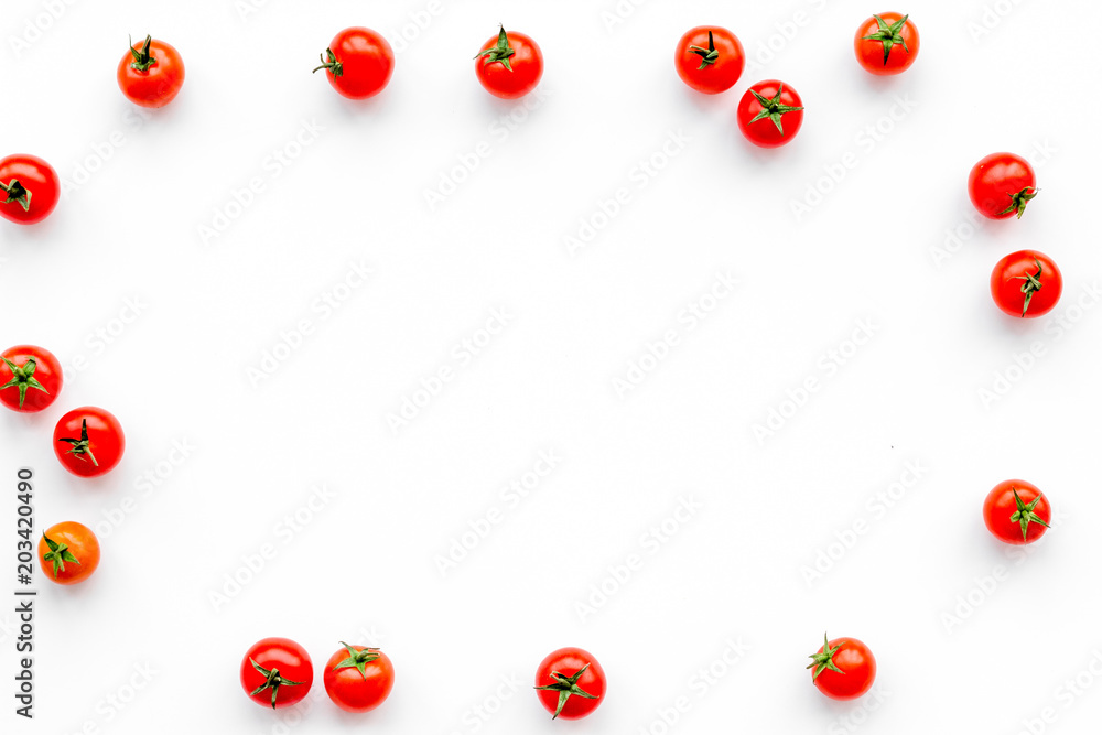 Fresh red cherry tomatoes scattered on white background top view copy space Fresh red cherry tomatoes scattered on white background top view copy space