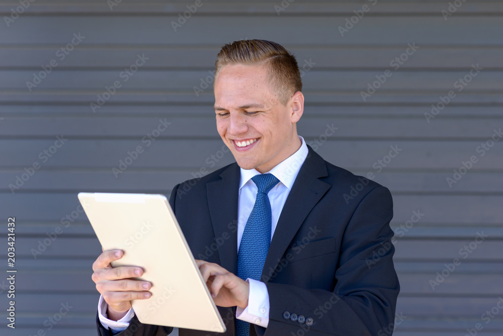 Young businessman using his tablet-pc Young businessman using his tablet-pc