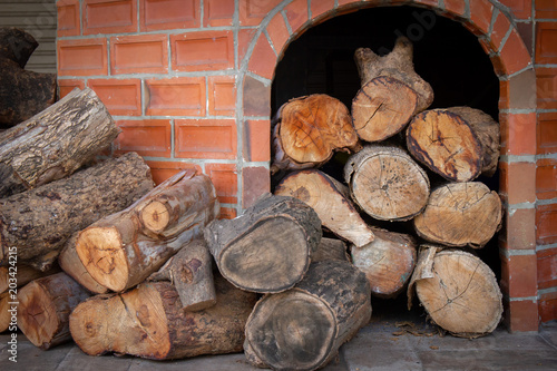 Firewood placed in a fire stove ready for fire. Firewood available.