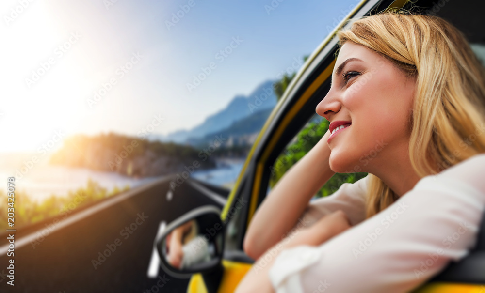 Travel or vacation. Beautiful blond girl in car on the road to the sea. Travel or vacation. Beautiful blond girl in car on the road to the sea.