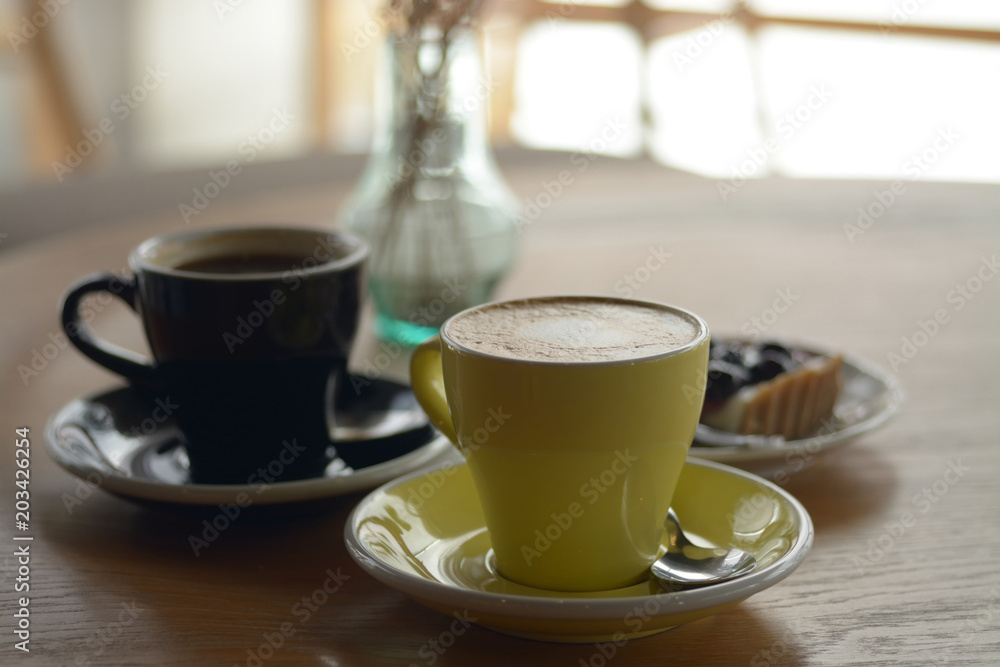 Cup of coffee and blueberry cheese pie on table in cafe Cup of coffee and blueberry cheese pie on table in cafe