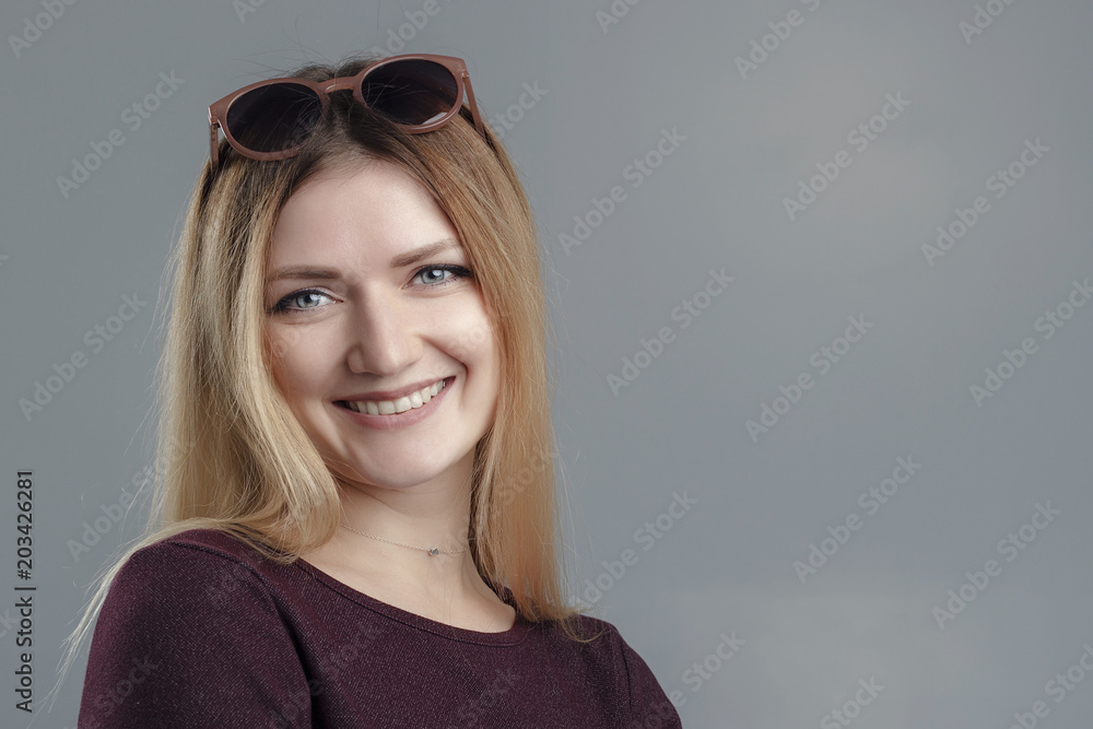 Woman beautiful skin blonde hair portrait close up studio on gray background Woman beautiful skin blonde hair portrait close up studio on gray background