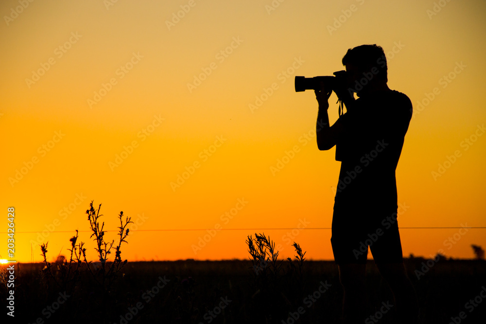  Silhouette of young photographer
