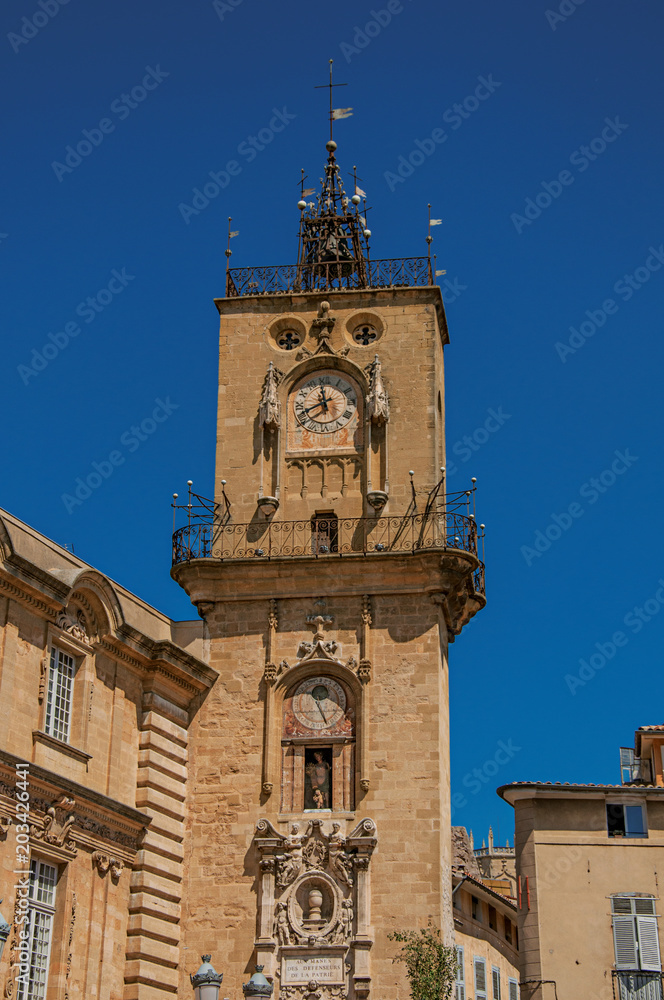 Close-up of clock tower with sunny blue sky in Aix-en-Provence, a pleasant and lively town in the French countryside. Located in Bouches-du-Rhone department, Provence region, southeastern France