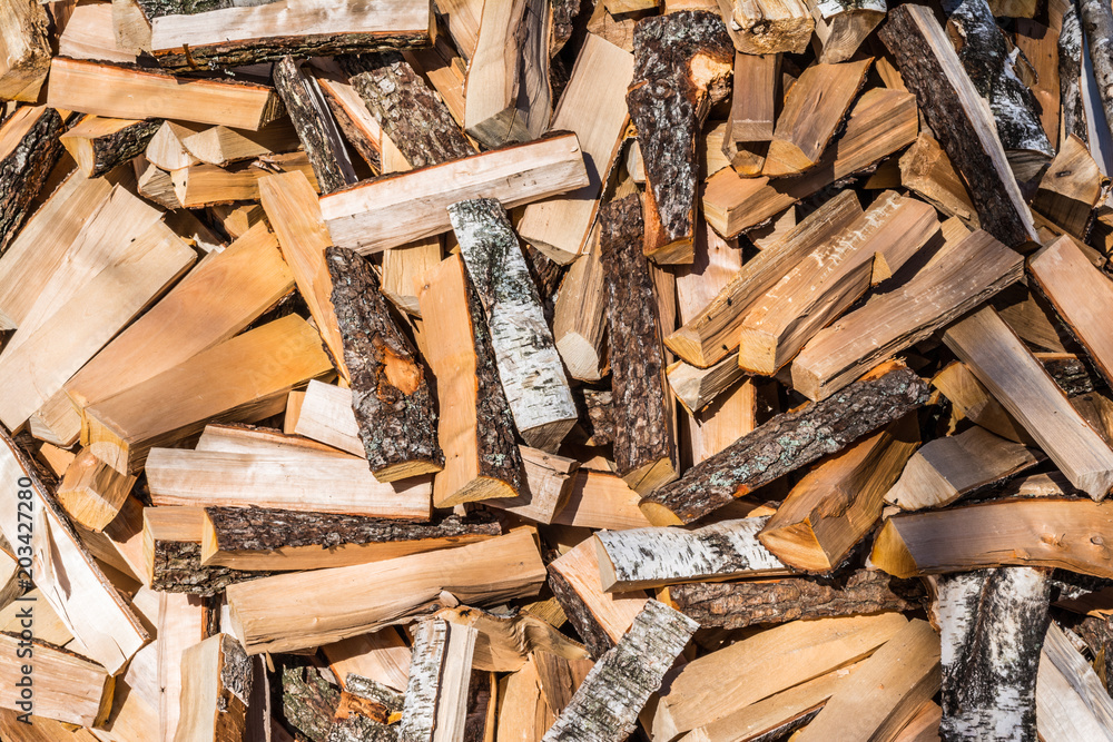chaotically arranged in a pile of fresh chopped firewood, abstract background chaotically arranged in a pile of fresh chopped firewood, abstract background