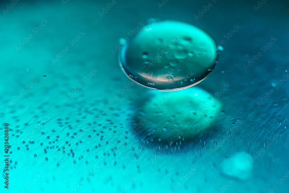 Colored oil drops and bubbles on a metal gear engine surface. Closeup photo. Colored oil drops and bubbles on a metal gear engine surface. Closeup photo.