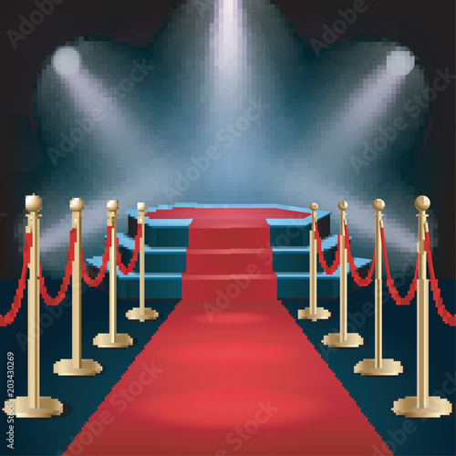 Podium with red carpet and barrier rope in glow of spotlights