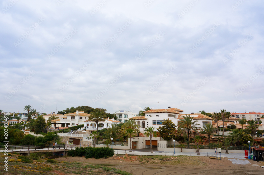 Playa Flamenca beach, spain, landscape on cloudy weather, private properties urbanization 