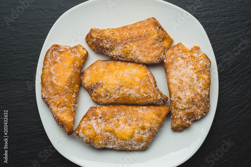 Typical spanish sweets, Fritters with sugar or pestinos photo