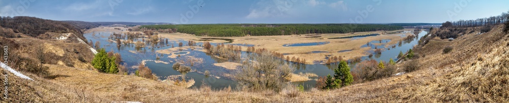 Spring landscape, panorama - spring flood in river valley of the Siverskyi (Seversky) Donets, the winding river over the meadows between hills and forests, border region of Ukraine near to Russia Spring landscape, panorama - spring flood in river valley of the Siverskyi (Seversky) Donets, the winding river over the meadows between hills and forests, border region of Ukraine near to Russia