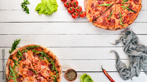 Set pizza. Italian cuisine. Top view. On a wooden background. Copy space.