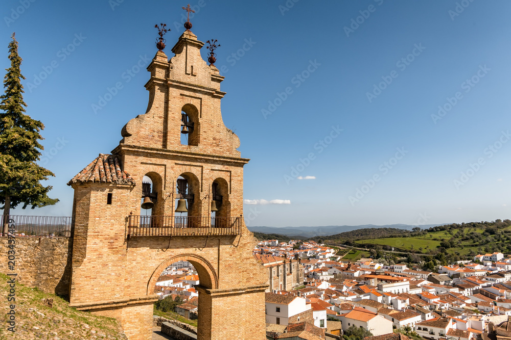View of bell tower near the castle of Aracena, Spain, and picturesque village below.