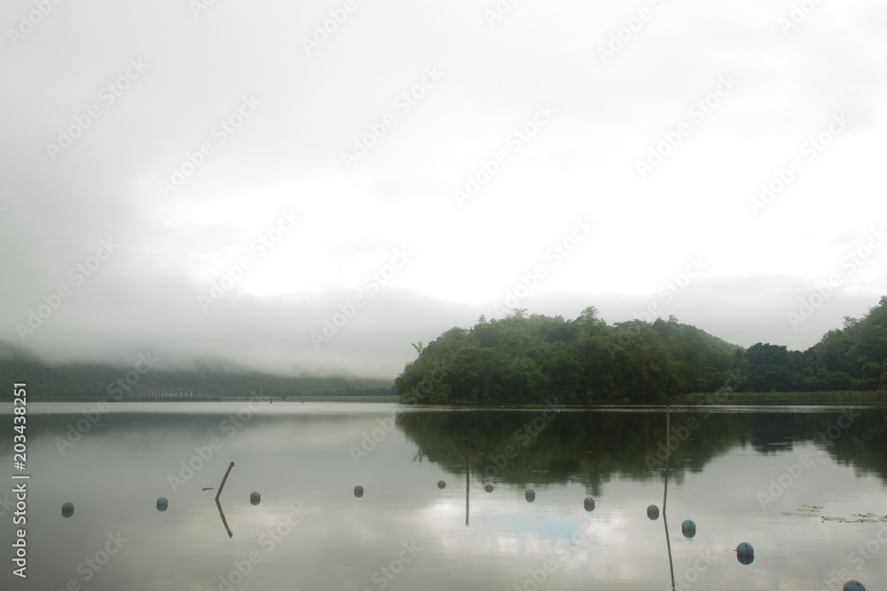 Landscape of Mountain on  Reservoir Tha Thung Na under cloudy on morning at Kanchanaburi Province of Thailand.
