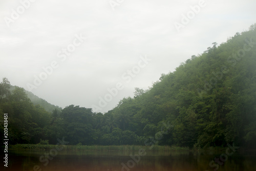 Landscape of Mountain on Reservoir Tha Thung Na under cloudy on morning at Kanchanaburi Province of Thailand.