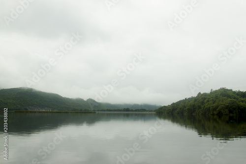 Landscape of Mountain on Reservoir Tha Thung Na under cloudy on morning at Kanchanaburi Province of Thailand.