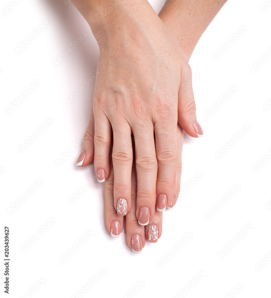 Female hands. Beautiful modern manicure with floral ornament on a white background. Closeup Female hands. Beautiful modern manicure with floral ornament on a white background. Closeup