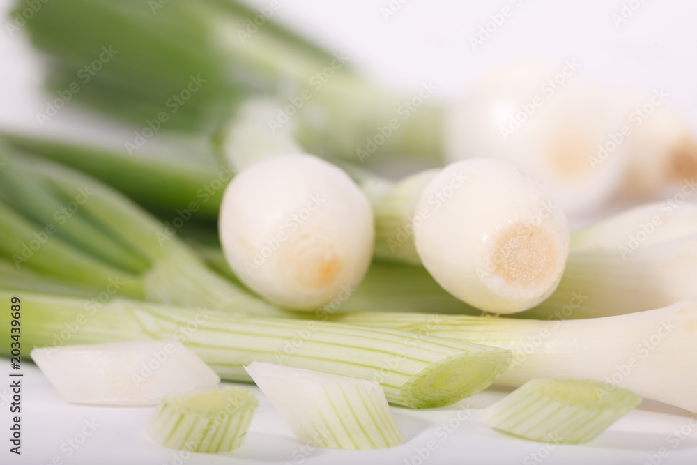 Fresh healthy spring onions on white background. Choped green onions. close up image. Fresh healthy spring onions on white background. Choped green onions. close up image.
