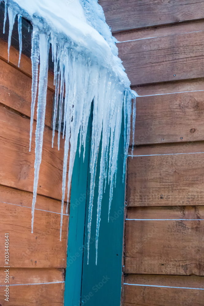 icicles on a wooden structure in winter after snowstorm icicles on a wooden structure in winter after snowstorm