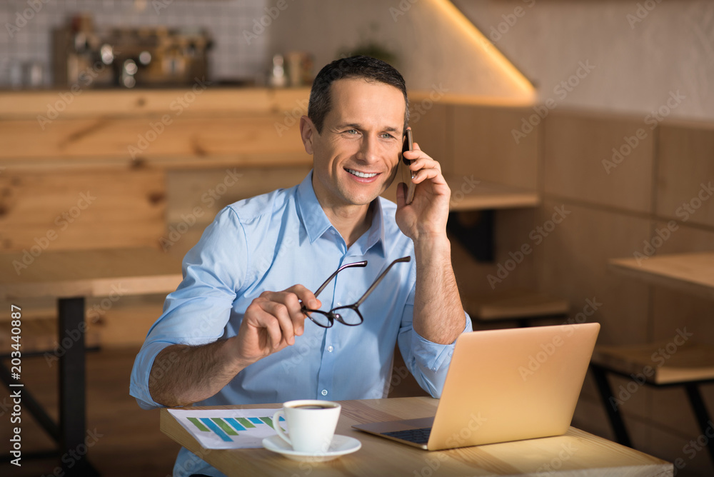 businessman talking on smartphone in cafe businessman talking on smartphone in cafe