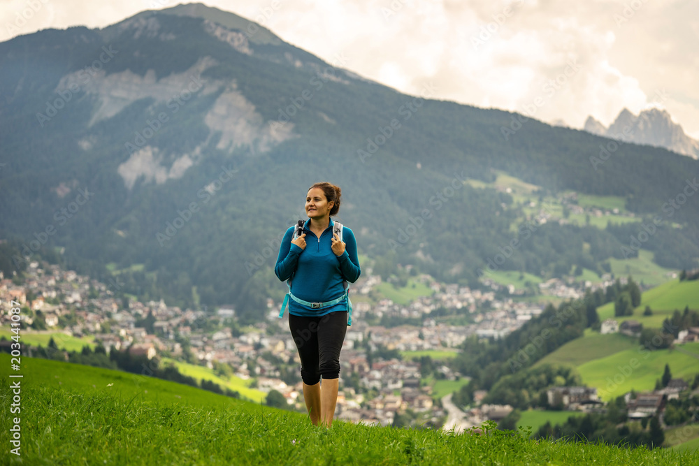 Young woman enjoying beautiful hike in Italian Dolomites. Hikking a trail in famous Dolomites, Italy.