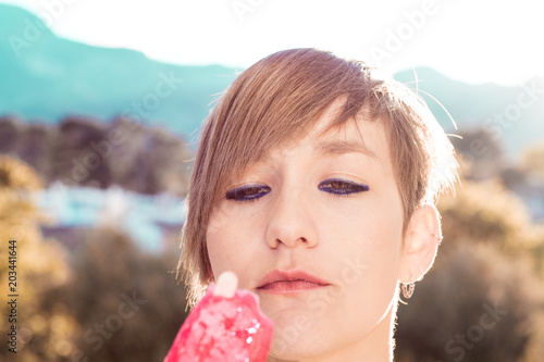 Close-up of a beautiful young woman eating ice cream