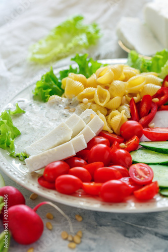 Vegetable salad with pasta,artisanal cheese and pine nuts.