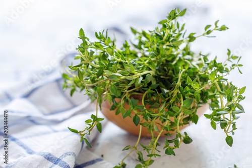 Fresh thyme in a wooden bowl.