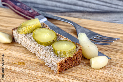 Marinated cucumber on a piece of bread photo