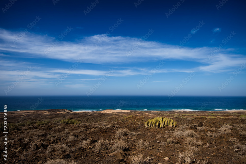 Blu sky, white clouds, atlantic ocean, lonely beach on Fuerteventura, Cofete