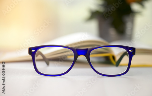 Stylish blue glasses on a blur background.