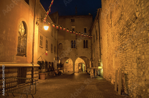 Night view of alley with walls and stone arches in the village of Vence, a stunning medieval town completely preserved. Located in the Alpes-Maritimes department, Provence region, southeastern France