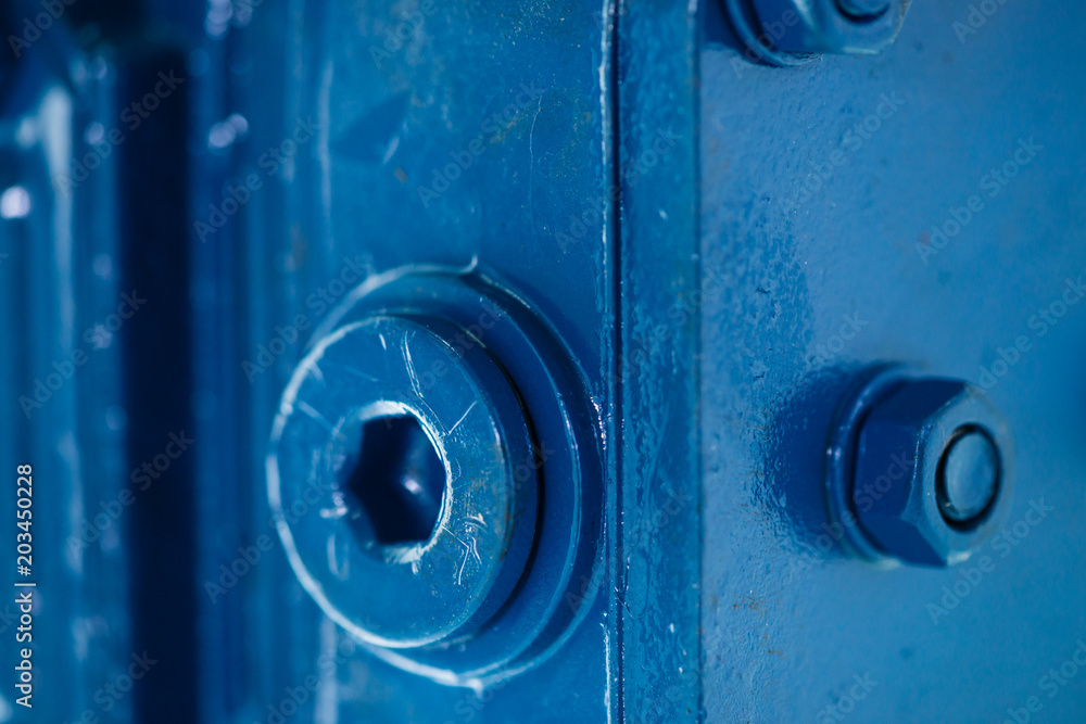 Blue metal rough surface of part with bolts and nuts. Blue painted of auto part. Automotive grunge background image. Blue metal rough surface of part with bolts and nuts. Blue painted of auto part. Automotive grunge background image.