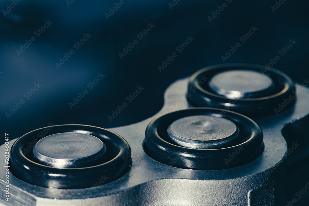 Part of the complex mechanism close-up on a background of a dirty glass. Part of the complex mechanism close-up on a background of a dirty glass.