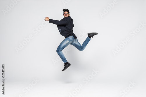 Excited Indian businessman jumping for joy isolated on white background.